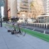bike racks on the sidewalk, protected bikeway, and bikeshare station
