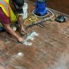 Dan Alger from mechanical system group replaces worn and broken floor tiles