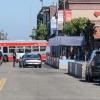 19 Polk Bus turning onto Beach Street while a biker bikes and passenger loading occurs in front of Ghirardelli Square