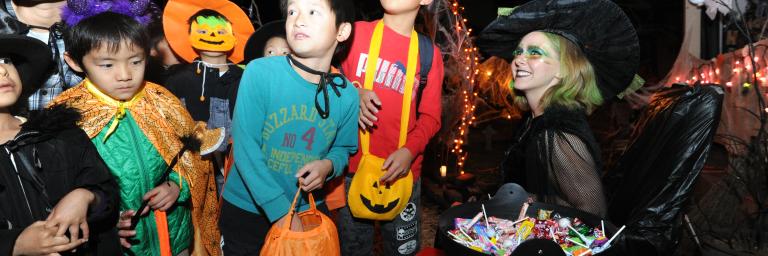 kids in halloween costumes on a dark street