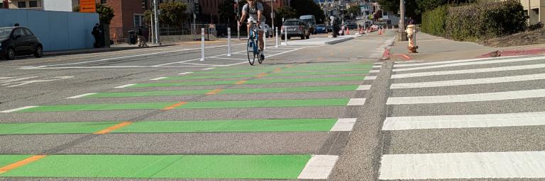 A person biking south on Frida Kahlo Way.