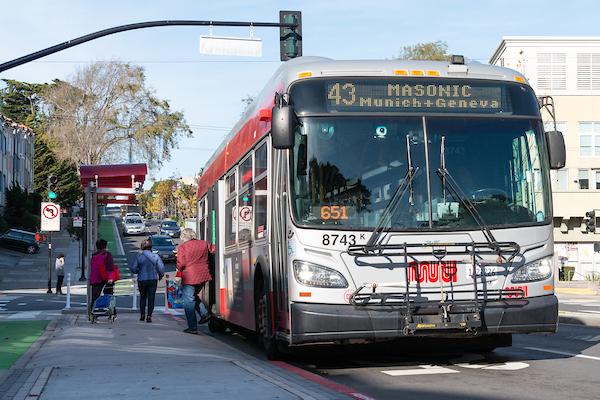 43 Masonic bus picks up passengers at a boarding island. 