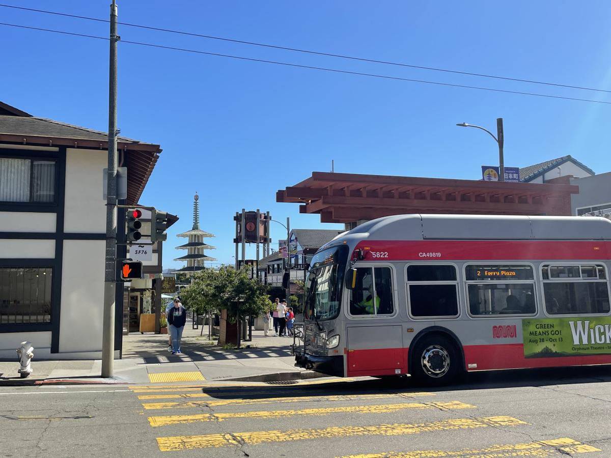 A 2 Ferry Plaza bus enters a crosswalk next to Japantown.