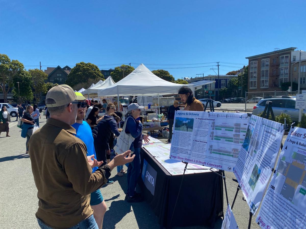 SFMTA staff engaging with community members at the Divisadero Farmers’ Market