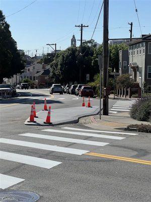 On Vicente Street, a new concrete island extends into the intersection at Wawona Street 