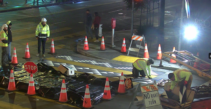 Crews work to install decorative crosswalk at 16th and Mission streets.