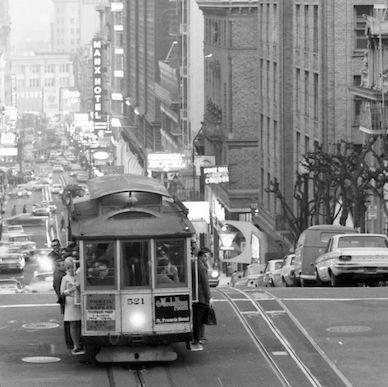 Evening shot of people riding a San Francisco cable car on Powell Street in 1968.