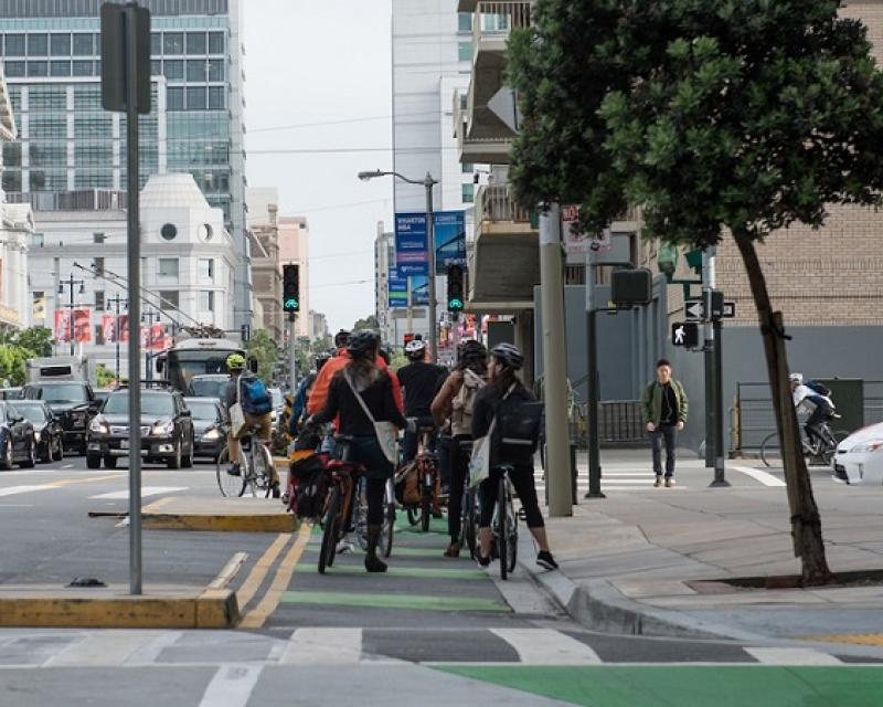 Bike commuters in a protected bike lane on Polk Street at Hayes Street on Bike to Work Day 2016.