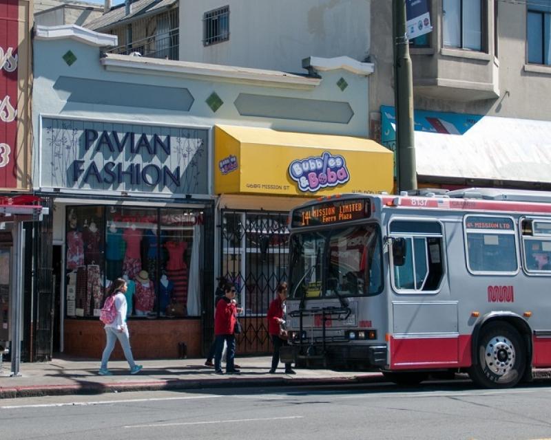 A 14 Mission Muni trolley bus stopped in front of local shops in the Excelsior district.