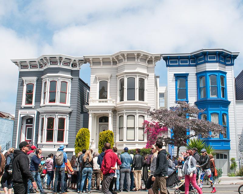 Sunday Streets event on Valencia Street in front of iconic San Francisco Victorian buildings