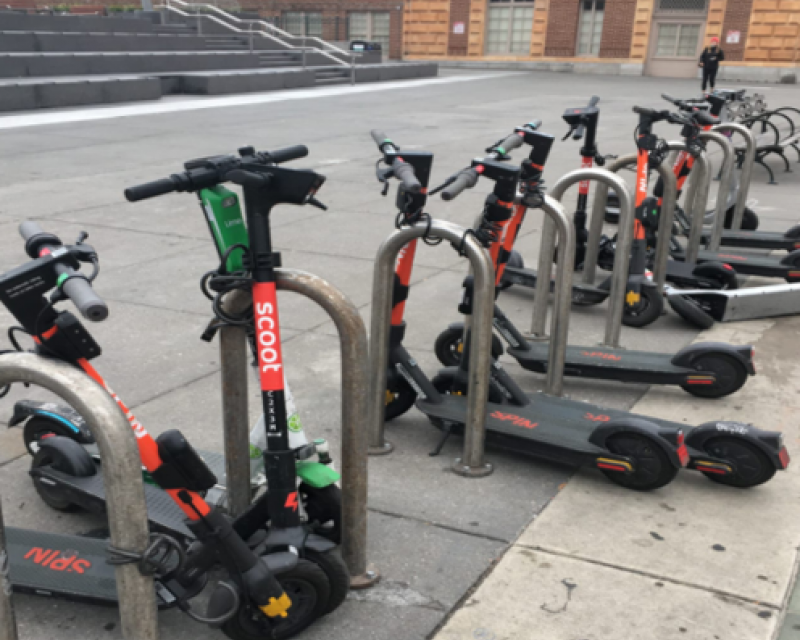 Scooters parked at bike racks