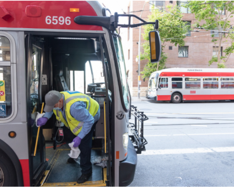 Picture of Muni Car Cleaner wiping down bus railings