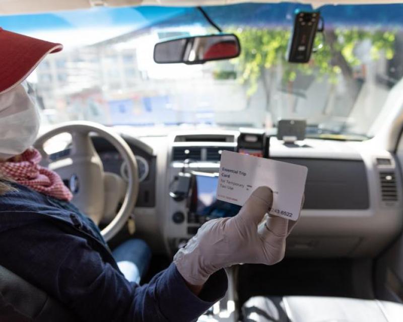 Taxi Driver Swiping Essential Trips Card for Fare Payment