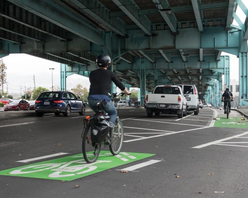 Parking-protected bike lane on 13th Street under the Central Freeway.