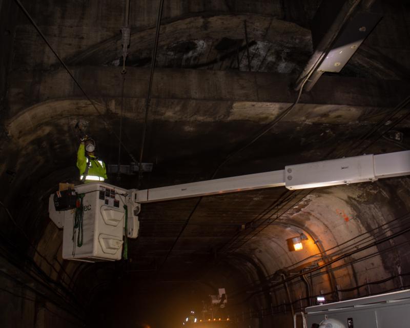 A worker inspects infrastructure in the Twin Peaks Tunnel