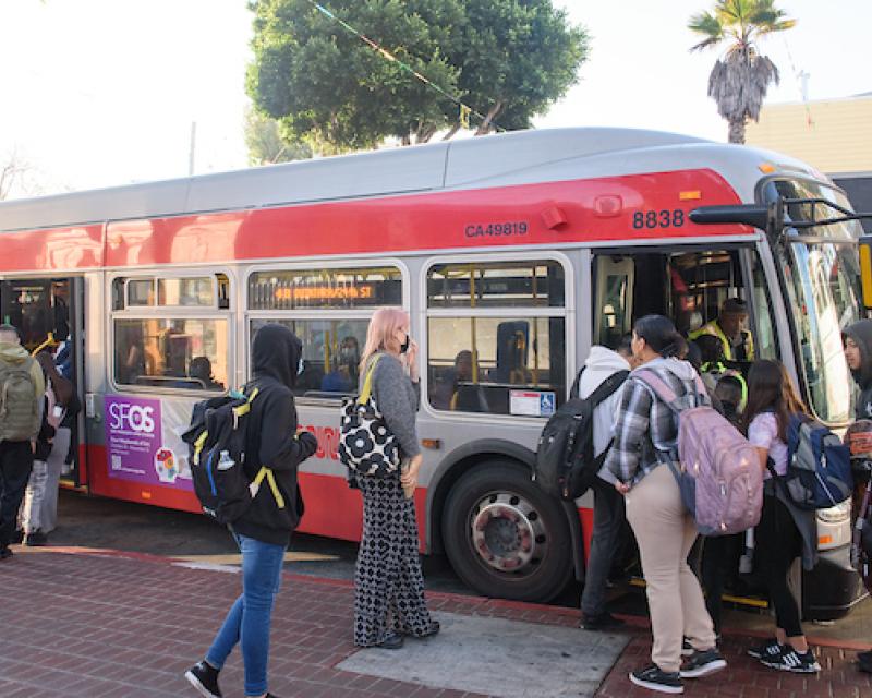 People stand in line to board the 48 Quintara at 24th and Mission streets.