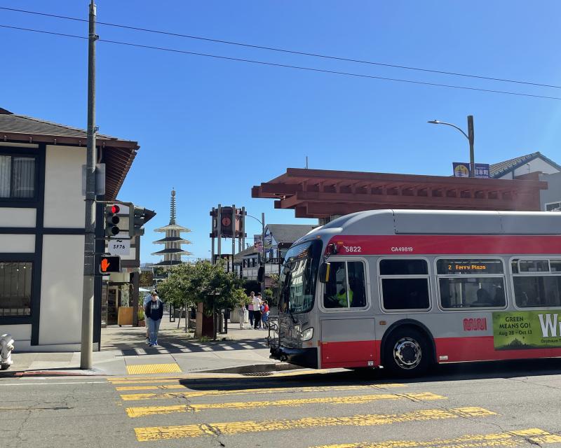 A 2 Ferry Plaza bus enters a crosswalk next to Japantown.