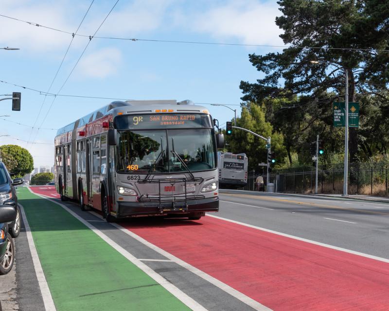 Image of the 9R San Bruno using a red transit-only lane that's beside a green lane for people biking.