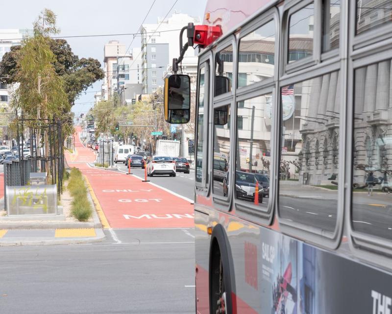 Closeup of a 49 Van Ness bus as it approaches a red, transit-only lane on Van Ness Avenue.