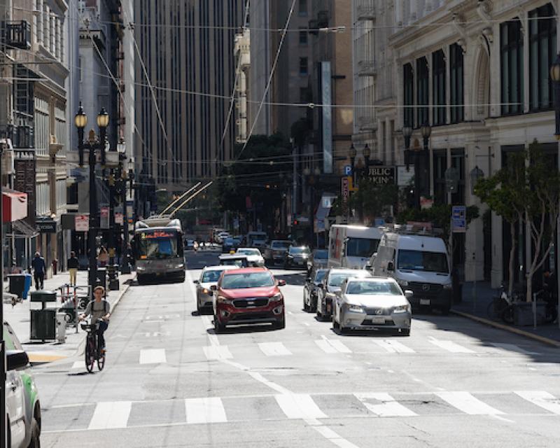 Cars, Bicycle and Muni Bus traveling westbound on sutter Street, viewed from the east.