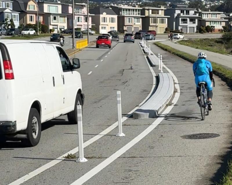 cyclist in completed bikeway on Lake Merced Blvd.