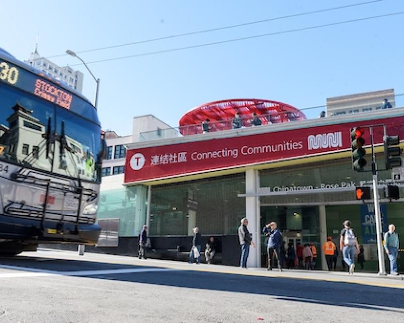 30 Stockton bus nears Chinatown-Rose Pak Station as people stand on the sidewalk in the background.