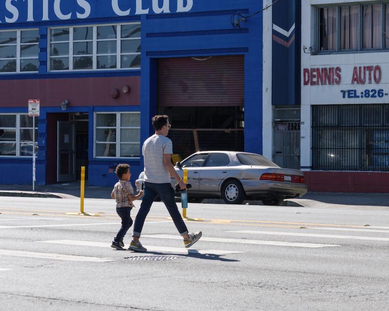 Pedestrians crossing the street post Bayshore Boulevard Quick-Build Implementation