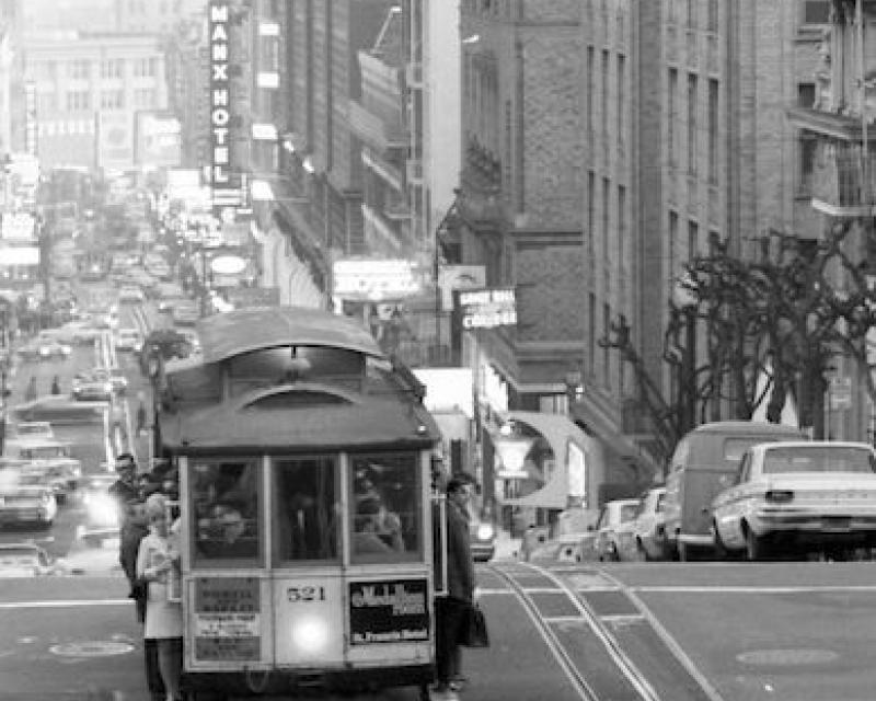 Evening shot of people riding a San Francisco cable car on Powell Street in 1968.