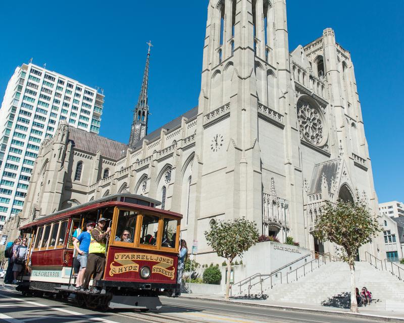 cable car passing grace cathedral on nob hill