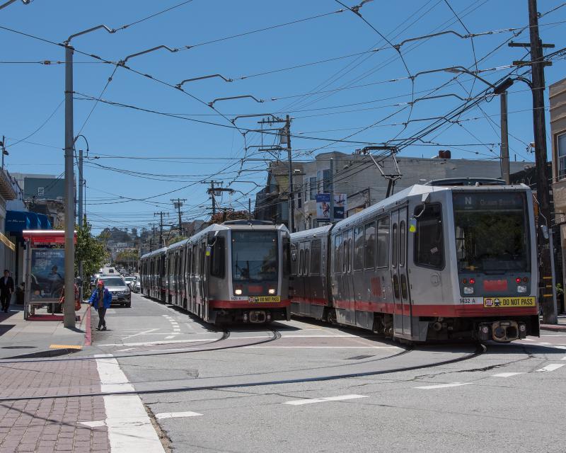 Two N Judah trains passing each other on 9th Avenue and Irving Street