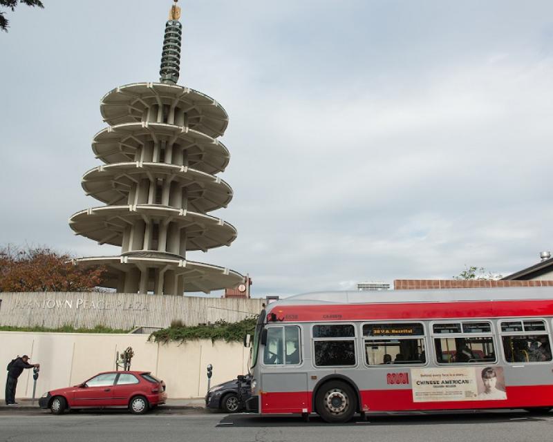 A 38 Geary coach stopping outside of Japantown.