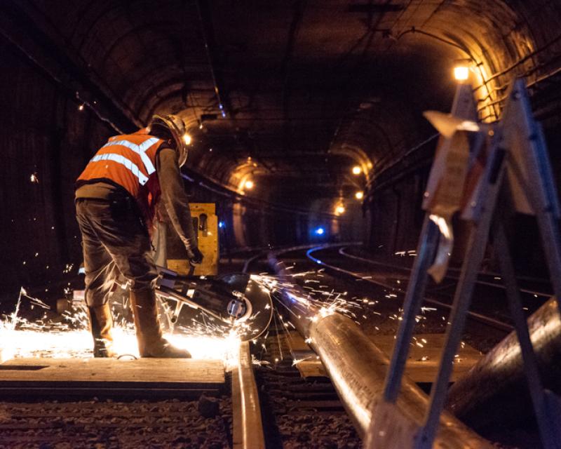 workers cutting rail