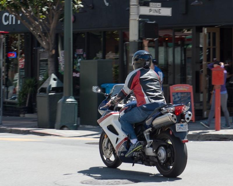 Motorcycle crossing Pine Street.