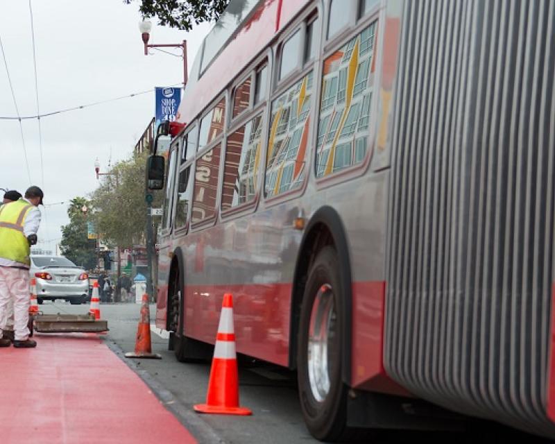 Crews putting down red transit lanes in the Mission