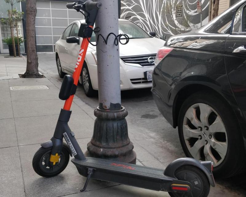 A Spin scooter parked with a lock-to device