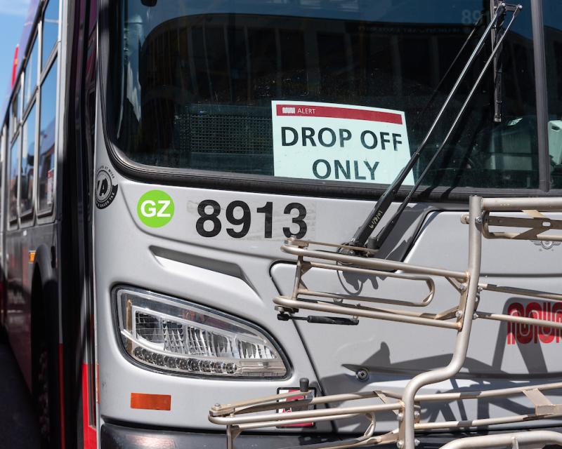 A Muni bus with a "Drop Off Only" sign.