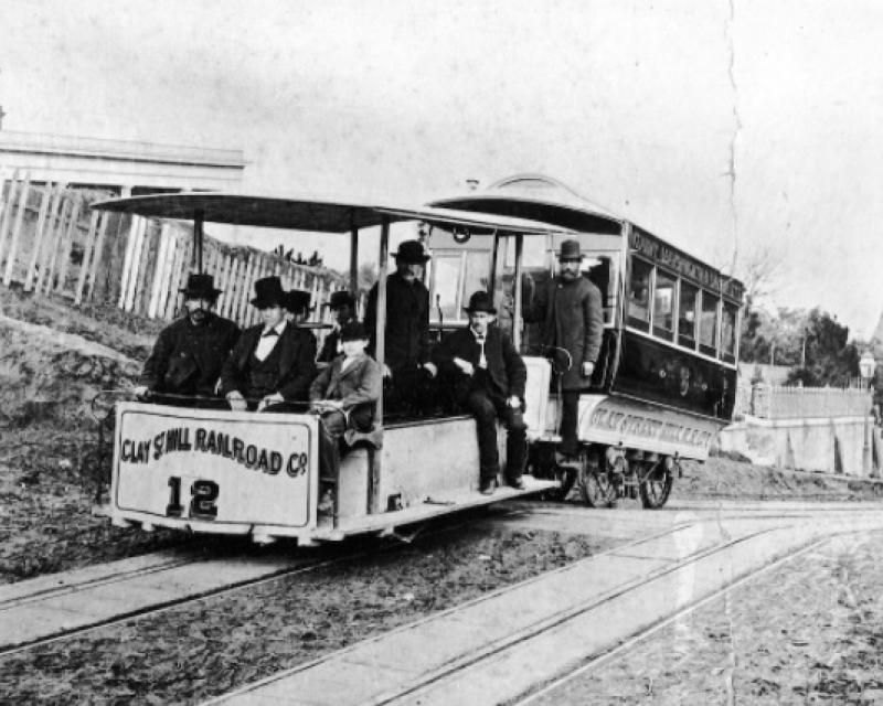 Photo of original cable car in late 1800s with male passengers on board