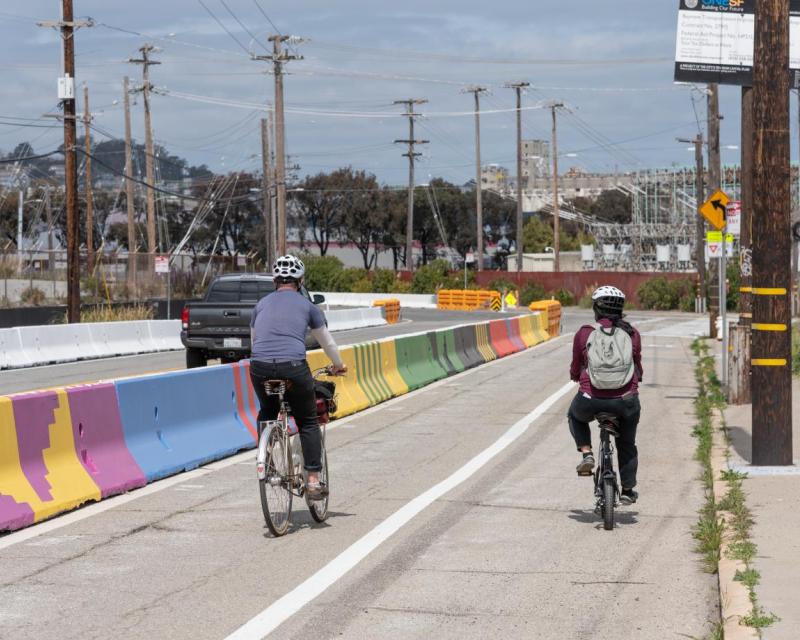 New protected bike lane on Hunters Point Blvd in the Bayview, concrete (mural) barriers designed by local artists 