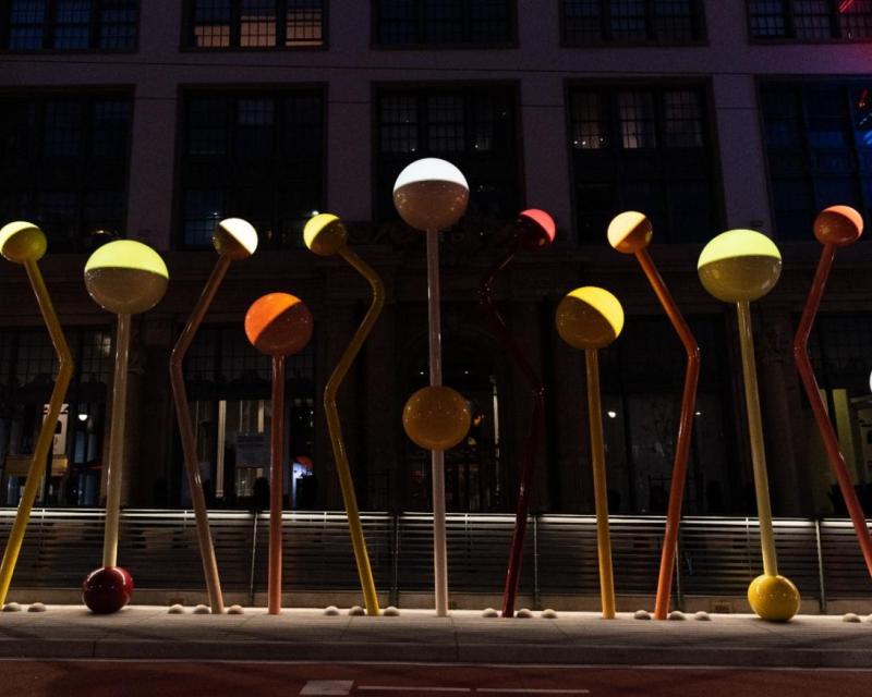 A light sculpture of colorful round orbs of light on bent and angled colored poles installed at Van Ness and O’Farrell streets