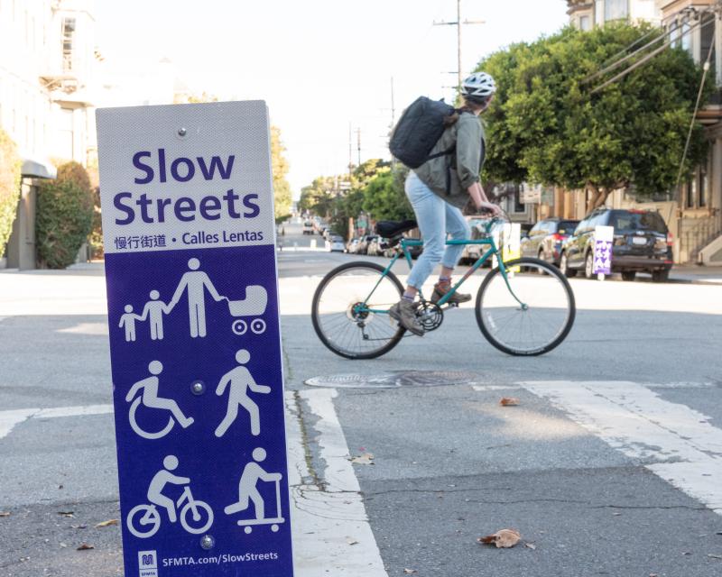 Cyclist rides across a Slow Street