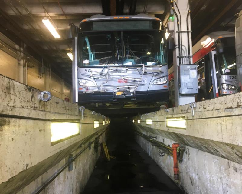 low-angle view of a bus over a maintenance pit